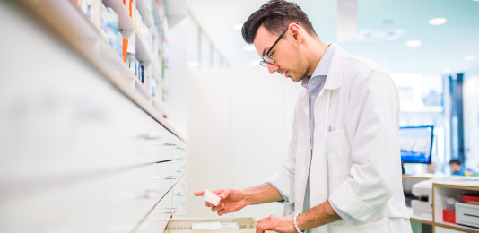 A pharmacist reading a medication label